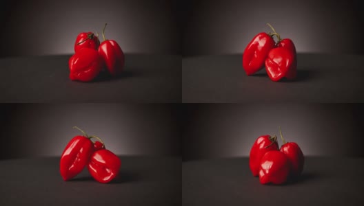 非常辣的红色哈瓦那辣椒在黑色的背景高清在线视频素材下载
