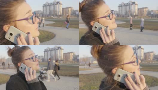 一个女孩在智能手机上走路和说话的特写慢动作镜头高清在线视频素材下载