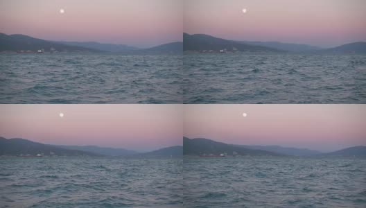 美丽的日落，山和海的一轮明月。高清在线视频素材下载