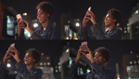 一名年轻女子在城市里拍摄夜景高清在线视频素材下载