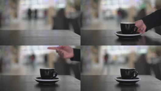 手把一个黑色的杯子放在桌上高清在线视频素材下载