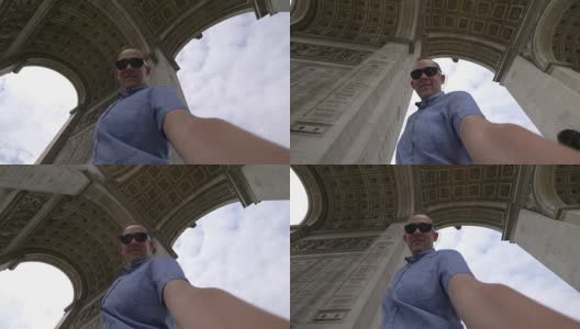 一名男子在用4k慢镜头拍摄巴黎凯旋门的自拍照高清在线视频素材下载