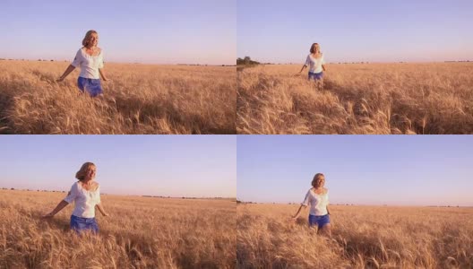 慢镜头中，一名年轻女子微笑着沿着乌克兰的麦田奔跑高清在线视频素材下载