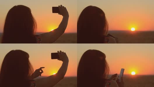日落时分，年轻的女孩正在用手机拍照片，天空中女孩的剪影高清在线视频素材下载