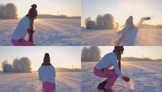 女人在夕阳下赏雪抛雪站在雪下高清在线视频素材下载