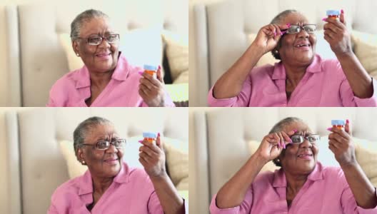 老年妇女试图阅读处方药瓶高清在线视频素材下载