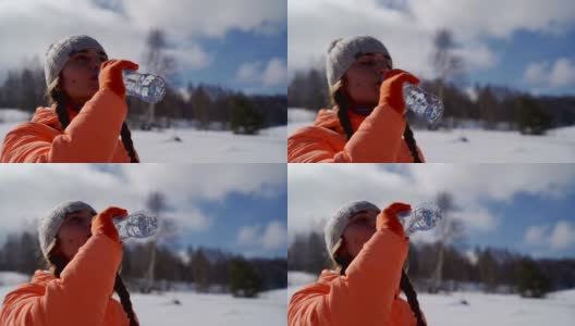 年轻美丽的女孩在山上喝着塑料瓶里的水高清在线视频素材下载