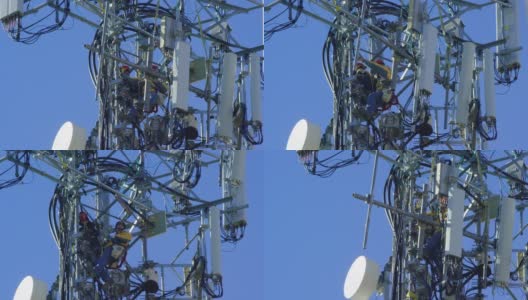 一个技术员组装一个手机塔的特写在一个晴朗，阳光明媚的日子高清在线视频素材下载
