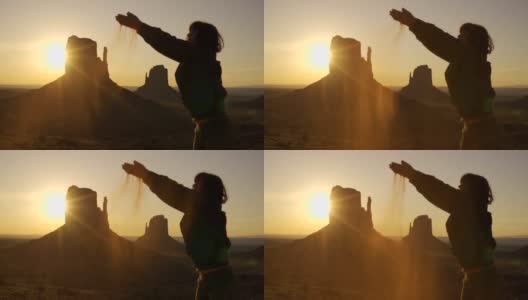 日出时，犹他州纪念碑谷的一位年轻女子穿着红色的沙子。美国高清在线视频素材下载