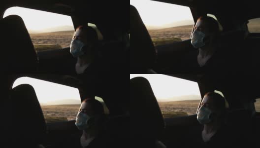 在隔离城市，一名男子在开车时戴着医用口罩。高清在线视频素材下载