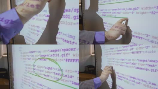 程序员与程序代码工作在一个交互式白板上的特写高清在线视频素材下载