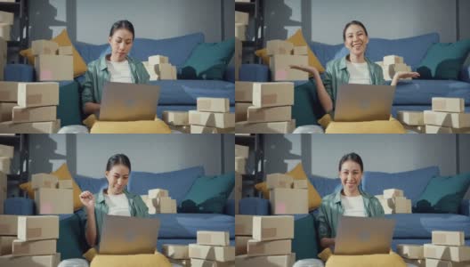 年轻的亚洲女售货员在网上商店使用笔记本电脑准备包裹发货给客户在家里。高清在线视频素材下载