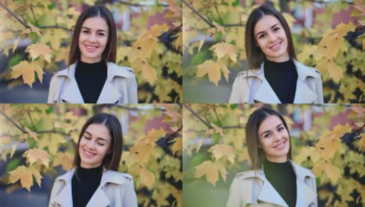 近距离女子微笑摆姿势在秋天的黄色树叶户外。中近距离拍摄4k红色相机高清在线视频素材下载