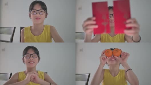 亚洲的中国女孩看着笔记本电脑的摄像头，拿着红包和橘子向她的祖父母祝贺春节高清在线视频素材下载