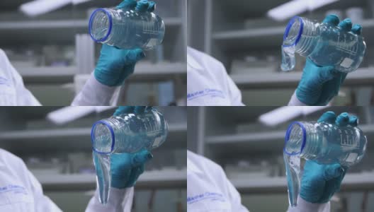 实验室助手从实验室的罐子里倒出透明的果冻高清在线视频素材下载