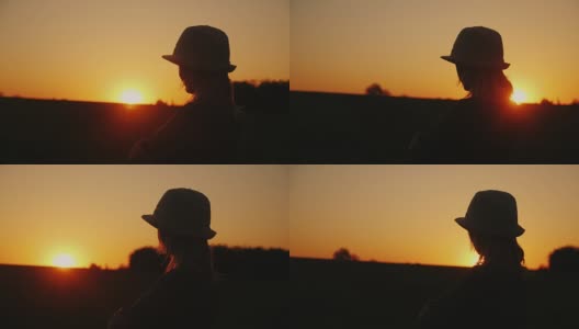 一个戴着帽子的年轻女子在风景如画的地方欣赏日落高清在线视频素材下载