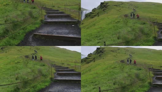 游客走在冰岛skogafoss瀑布的楼梯上，慢镜头高清在线视频素材下载