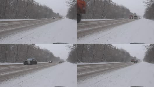 暴风雪期间冬日路上的汽车高清在线视频素材下载