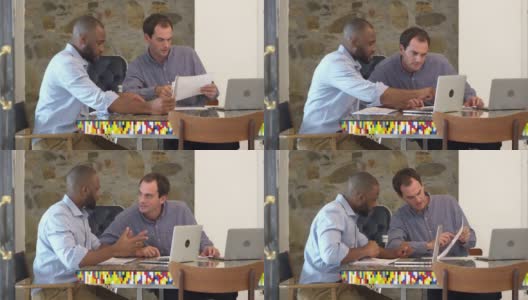 两个人一起在会议室的电脑前工作，慢镜头高清在线视频素材下载