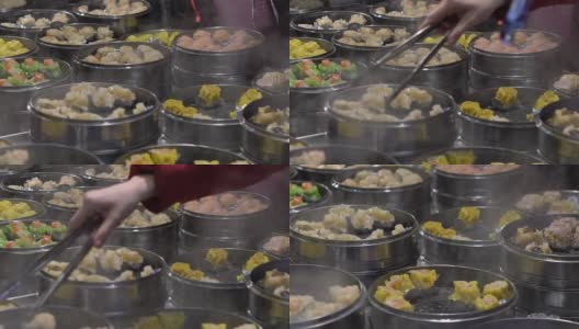 慢镜头小贩在亚洲街头小吃市场卖饺子和烧卖高清在线视频素材下载