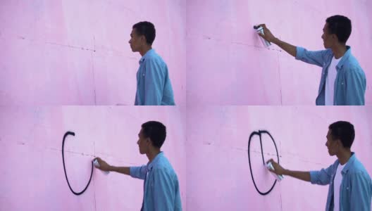 惊恐的少年用喷漆在墙上画和平符号，阻止种族主义高清在线视频素材下载