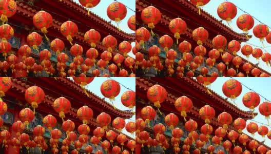 许多人在神龛里摆着中国新年装饰的灯笼。彩灯上的祝福文字寓意拥有财富和幸福高清在线视频素材下载