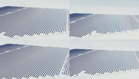空中视角太阳能电池板农场绿色能源在冬季雪晴天高清在线视频素材下载