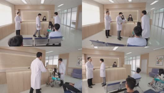 亚洲男医生在医院或医疗机构大堂向年轻女病人询问健康问题。一群医生帮助坐在轮椅上的生病妇女。医疗保健服务理念。高清在线视频素材下载