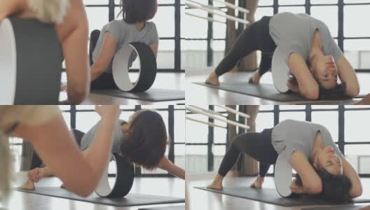 4K群亚洲女性在瑜伽馆一起使用瑜伽器材进行瑜伽训练。高清在线视频素材下载