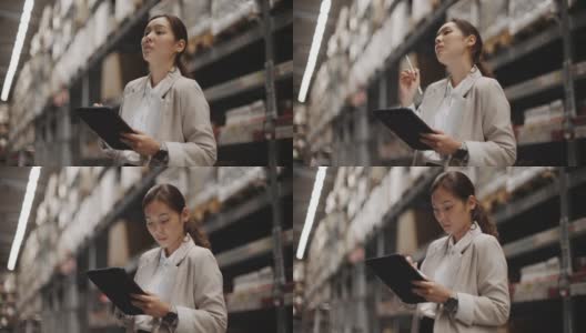 女商人在仓库里使用数码平板电脑高清在线视频素材下载