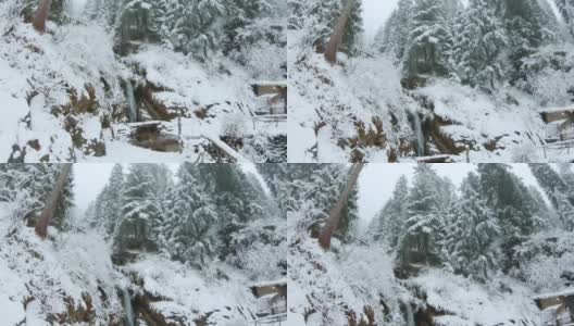 喜马偕尔邦马纳里降雪期间的嘉那瀑布。瀑布在冬天的雪在马纳里，假日背景，旅游概念。马纳利的冬季降雪。高清在线视频素材下载