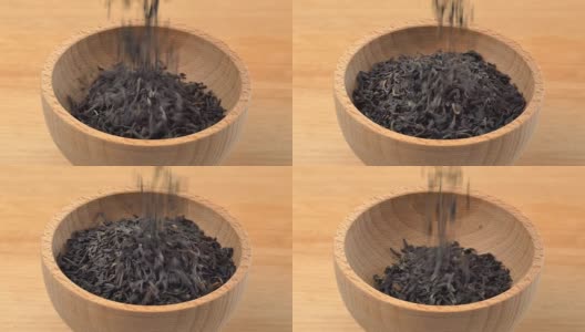 云南红茶倒入木质背景上的木碗中。缓慢的运动。高清在线视频素材下载