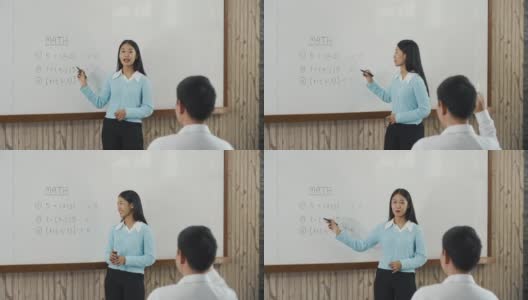 年轻的亚洲教师在教室里教学生。高清在线视频素材下载