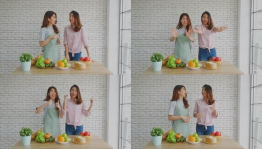 两名年轻的亚洲女性美食博主竖起大拇指，并在录制视频广播，视频博客健康的生活方式高清在线视频素材下载
