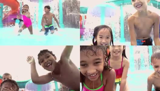 多民族儿童在水上乐园嬉戏，溅水花高清在线视频素材下载