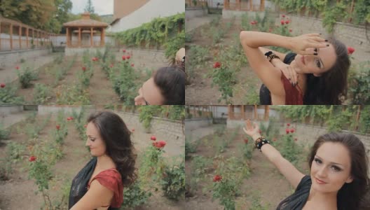 美丽的褐发肚皮舞与迈赫迪在身体上很好地移动靠近玫瑰在花园里的慢动作高清在线视频素材下载
