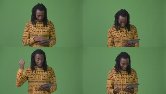 年轻英俊的非洲男子，长发绺映衬着绿色的背景高清在线视频素材下载