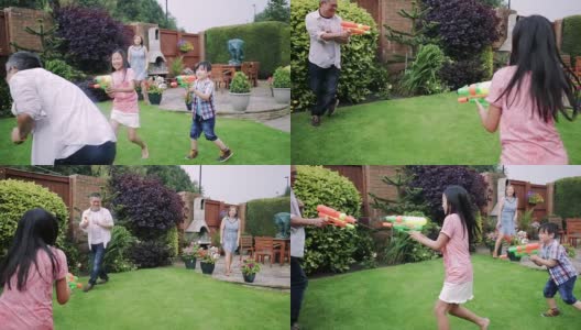 一家人在花园里打水仗高清在线视频素材下载