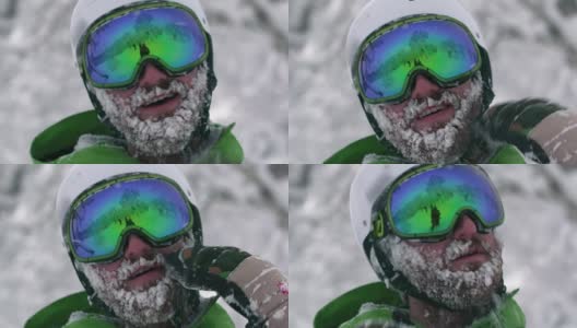 戴着头盔的滑雪者滑雪者登山运动员大胡子满是雪花从冰冻的脸上摇下来高清在线视频素材下载