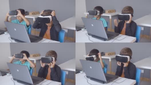 两位同学在课桌上戴上VR眼镜高清在线视频素材下载