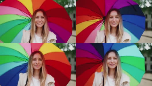 白种女人微笑着捻着五颜六色的伞高清在线视频素材下载