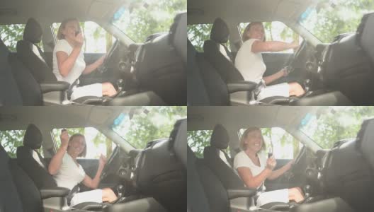 快乐的老女人开车坐在新车里，用钥匙跳舞，微笑着看着镜头享受旅程。驾驶课程和人寿保险概念。退休人员活动理念。高清在线视频素材下载