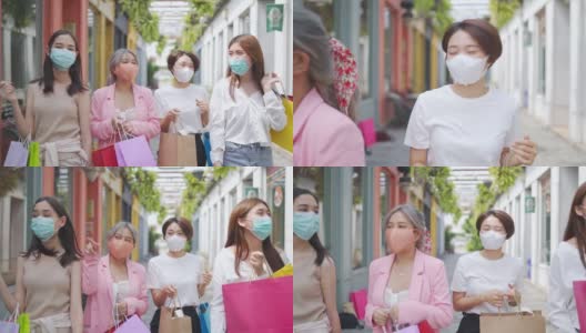 4K群亚洲女性朋友带着医用口罩一起逛街市。高清在线视频素材下载