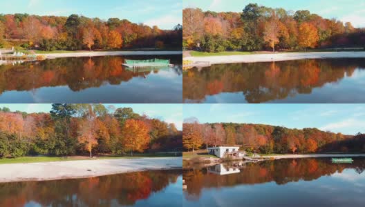 无人机低飞倒影湖，朝着海滩和多彩的秋天树叶高清在线视频素材下载