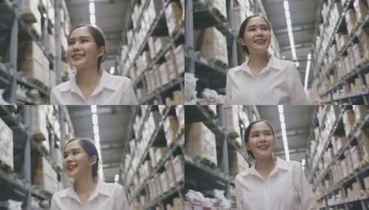 微笑的亚洲女人在购物中心或仓库散步快乐。女员工在工厂清点存货。购物业务概念高清在线视频素材下载