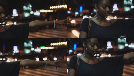 年轻的黑人妇女在城里等出租汽车高清在线视频素材下载