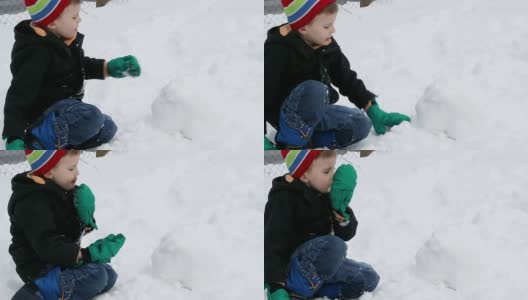 孩子吃雪和做雪球高清在线视频素材下载