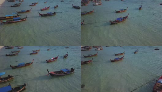 鸟瞰图跟踪长尾船和岩石海岸与水晶清澈的绿松石水Koh Lipe, Satun，泰国高清在线视频素材下载