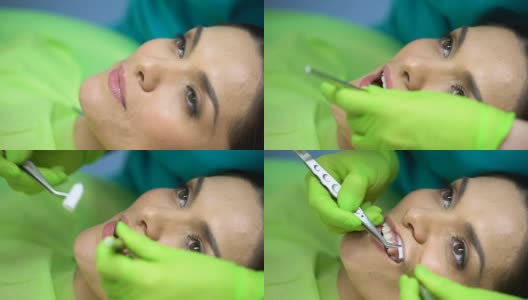 牙医将棉卷放在病牙附近，与唾液隔离，靠近高清在线视频素材下载