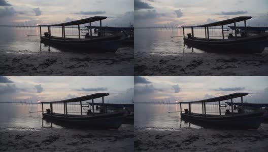 夕阳下海滩上的小船高清在线视频素材下载